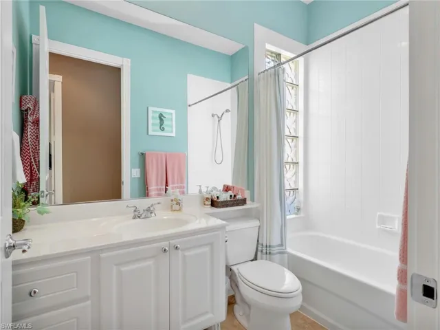 Bathroom with vanity and shower / tub combo