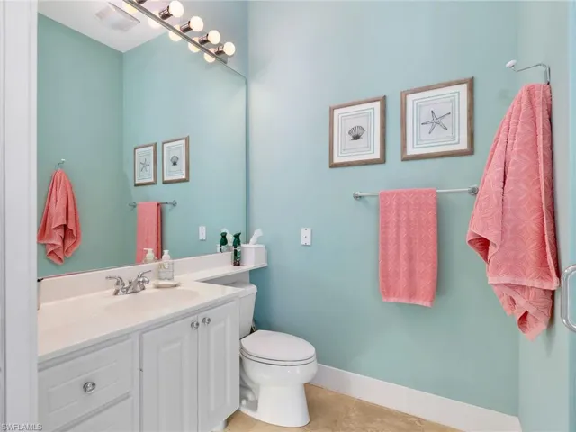 Half bath featuring vanity and light tile patterned flooring