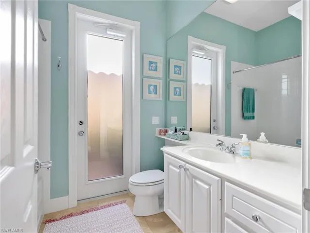 Bathroom featuring vanity, a shower, and light tile patterned floors