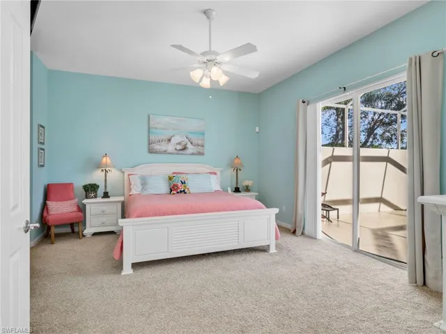 Carpeted bedroom with access to exterior and ceiling fan