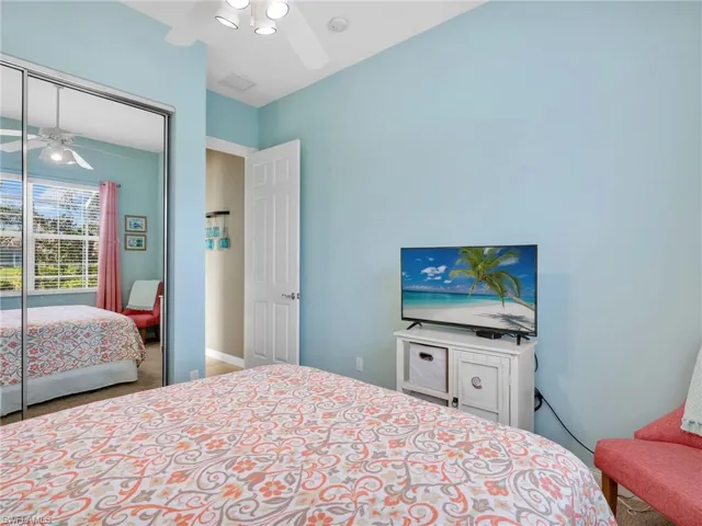 Bedroom with carpet flooring, ceiling fan, and a closet