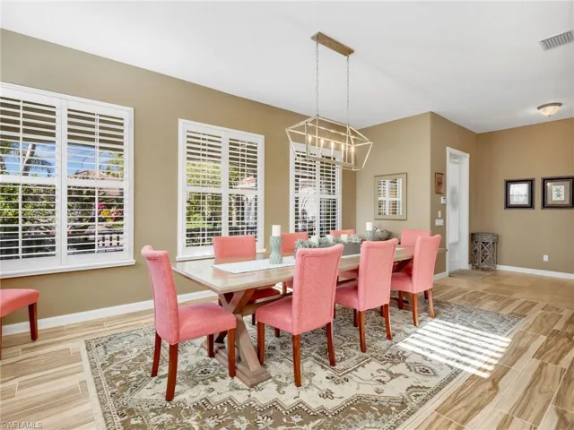 Dining space featuring wood finish floors and a chandelier