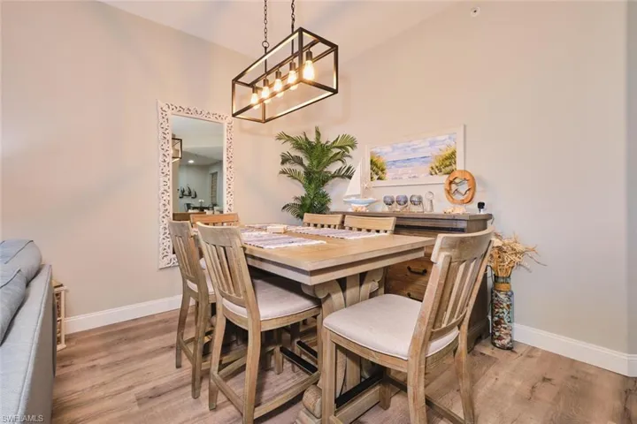 Dining room with light wood-style flooring and baseboards