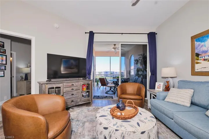 Living area with wood finished floors and ceiling fan
