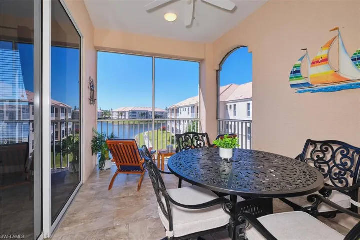 Sunroom with a water view and a residential view