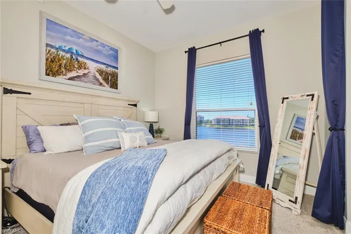 Carpeted bedroom featuring baseboards and ceiling fan