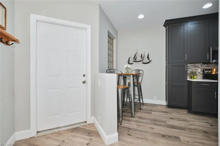 Foyer entrance with light wood-style floors and recessed lighting