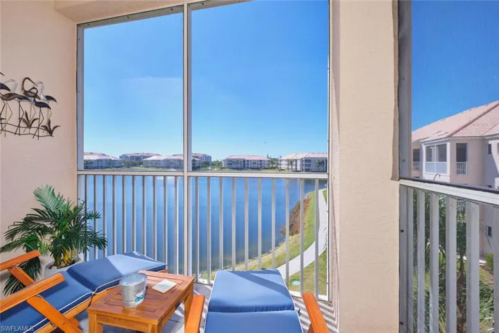 Balcony with a sunroom and a water view