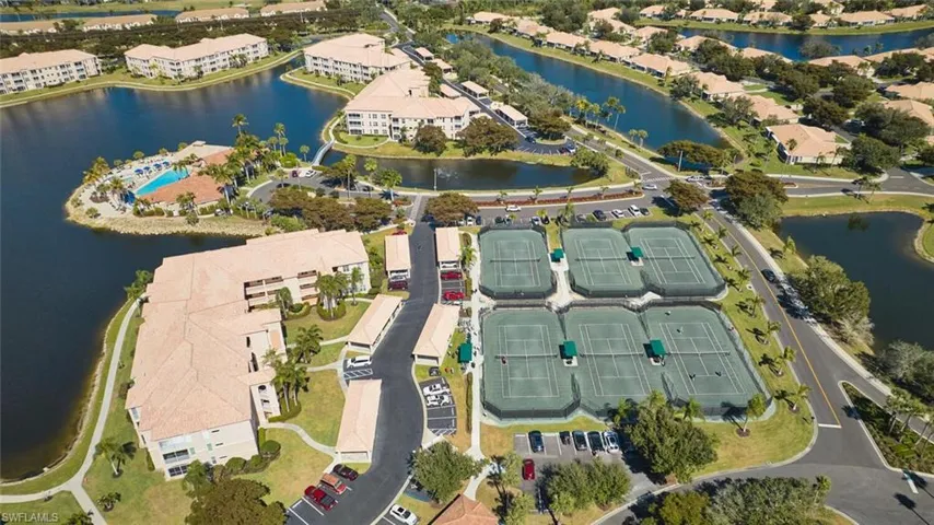 Aerial view of property and surrounding area featuring a large body of water and apartment complex / building