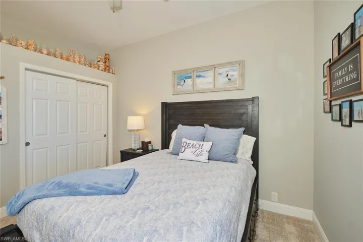 Bedroom featuring a closet and light carpet