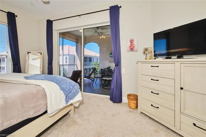 Bedroom featuring light colored carpet and access to outside