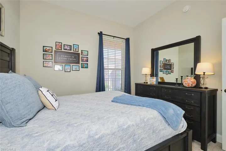 Bedroom featuring light carpet