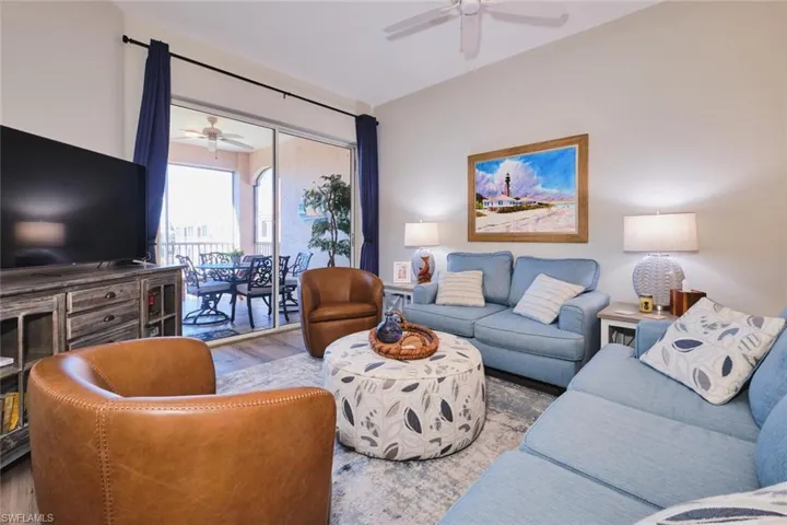Living area with ceiling fan and wood finished floors