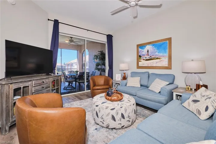 Living area with a ceiling fan and wood finished floors