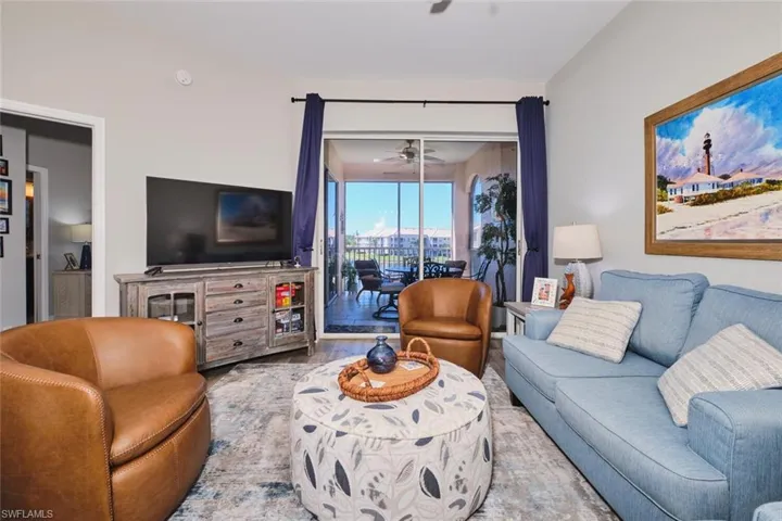 Living area with a ceiling fan and wood finished floors