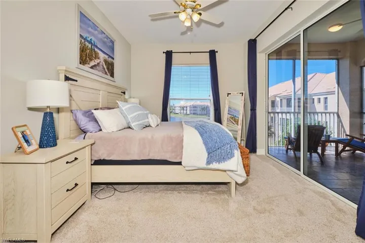 Bedroom with access to exterior, ceiling fan, and light colored carpet