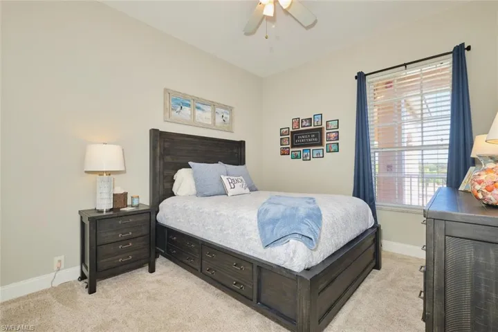 Bedroom featuring light carpet and ceiling fan