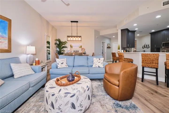 Living room with wood finished floors, recessed lighting, and a ceiling fan