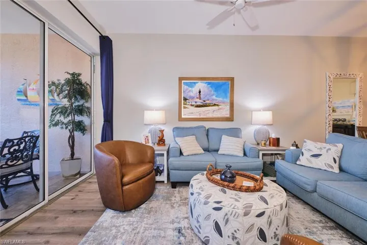 Living area featuring wood finished floors and a ceiling fan