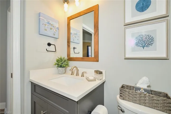 Half bathroom with vanity and toilet