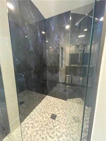 Master Bathroom with a shower with glass shower door