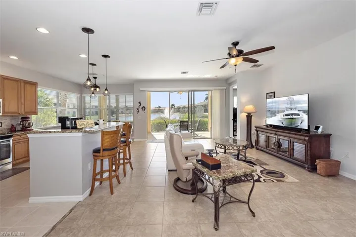 Living area featuring recessed lighting, a ceiling fan, and light tile patterned flooring