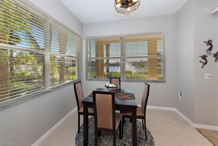 Dining space with light tile patterned floors and baseboards