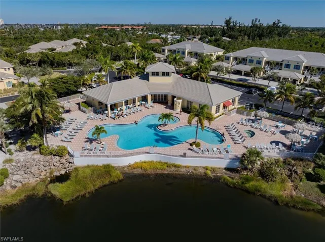 Drone / aerial view of a pool and a large body of water