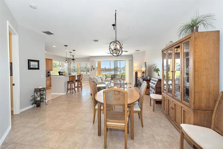 Dining room featuring light tile patterned floors and a chandelier