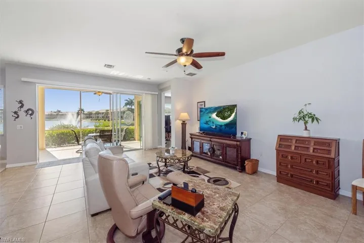 Living area featuring ceiling fan and light tile patterned floors