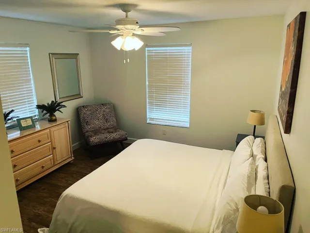 Bedroom with dark wood-type flooring and ceiling fan