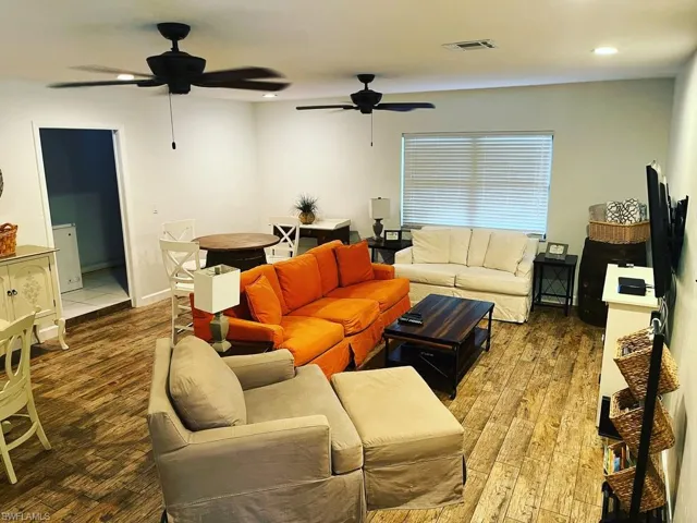 Living room featuring wood finished floors and recessed lighting