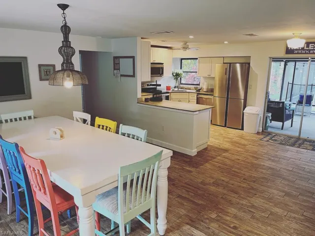 Dining space featuring dark wood finished floors and recessed lighting