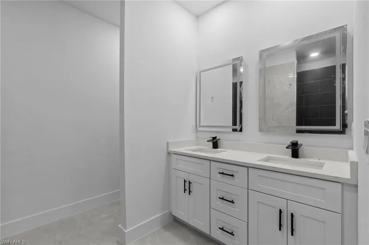 Bathroom featuring walk in shower and vanity