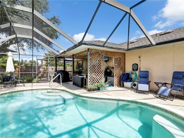 View of swimming pool featuring a lanai and a patio