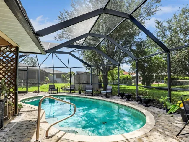 View of swimming Heated pool featuring a patio and a lanai
