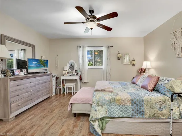 Bedroom with ceiling fan and wood-type flooring