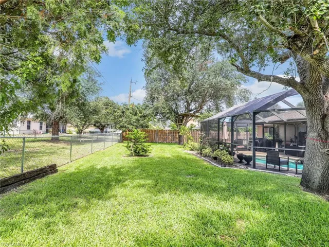 View of yard with a lanai and a fenced in pool