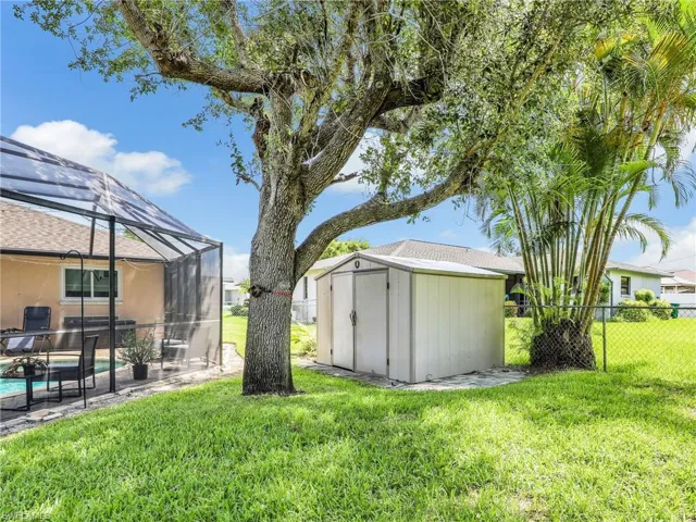 View of yard featuring  a shed, and a fenced in pool and yard.