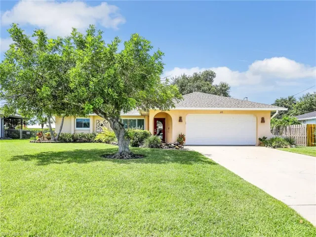 Ranch-style house with a garage and a front yard