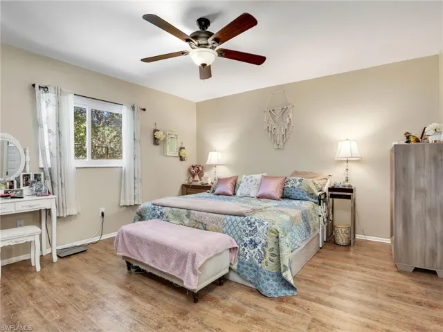 Bedroom featuring ceiling fan and hardwood / wood-style floors