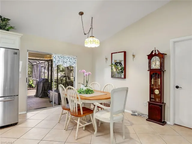 Tiled dining space with vaulted ceiling