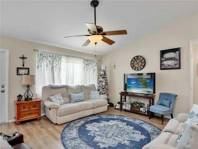 Living room featuring ceiling fan and wood-type flooring