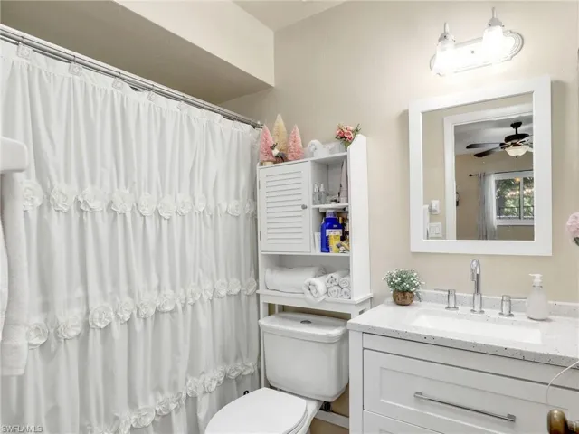 Master Bathroom with ceiling fan, toilet, and large vanity