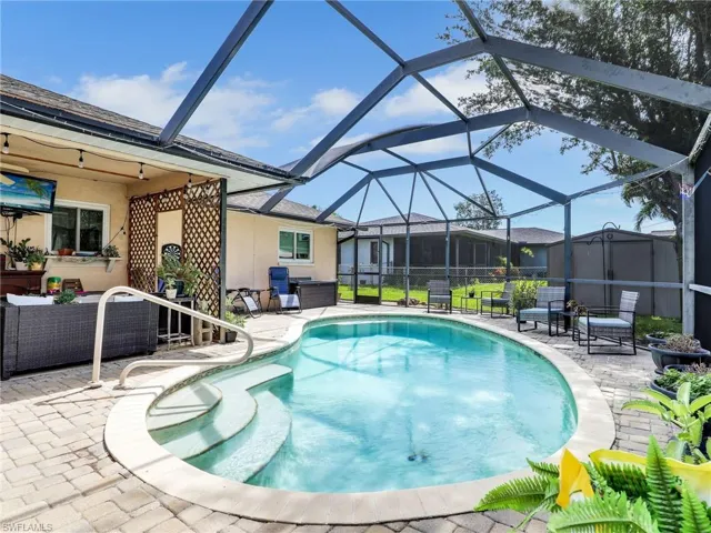 View of pool with a lanai and a patio
