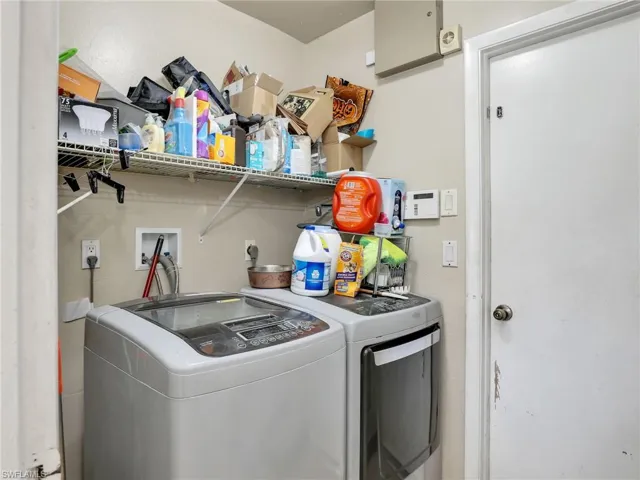 Clothes washing area featuring independent washer and dryer, hookup for an electric dryer, and washer hookup