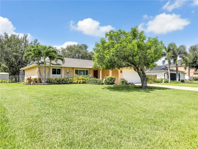 Ranch-style house with a front lawn and a garage