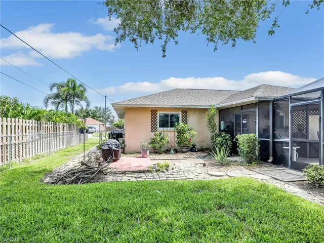 Rear view of house featuring a yard and a patio