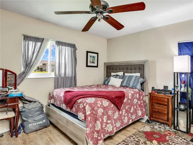 Bedroom featuring ceiling fan and hardwood / wood-style flooring