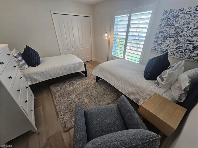 Bedroom with a closet and light hardwood / wood-style flooring